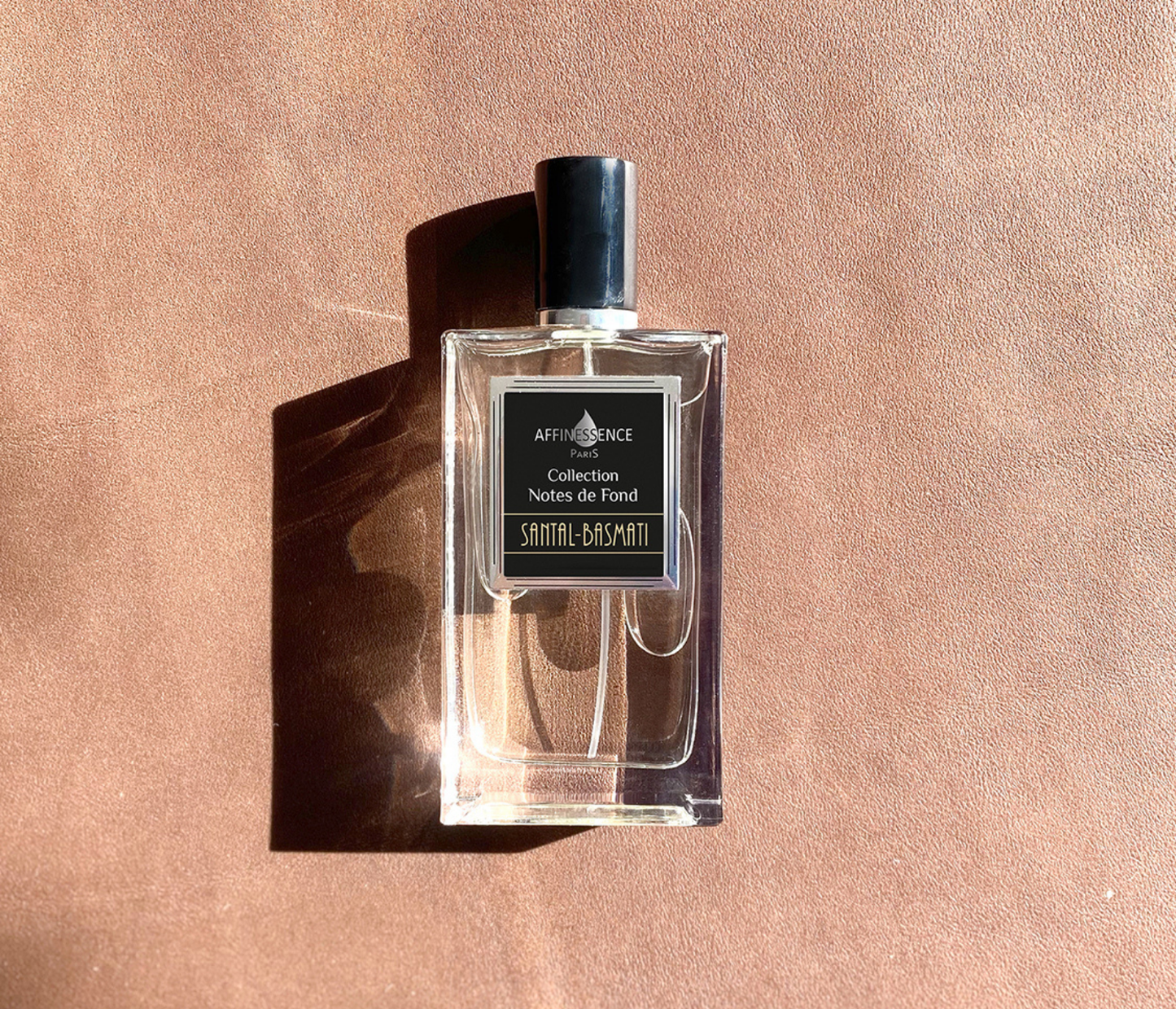 Affinessence Santal-Basmati perfume bottle on a pink background.