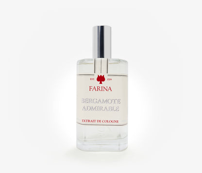 A bottle of the luxury perfume Bergamote Admirable by Farina 1709 set against a pale background.