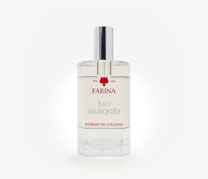 A bottle of the luxury perfume Eau Musquee by Farina 1709 set against a pale background.