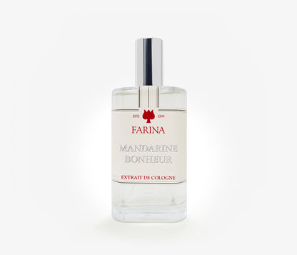 A bottle of the luxury perfume Mandarine Bonheur by Farina 1709 set against a pale background.