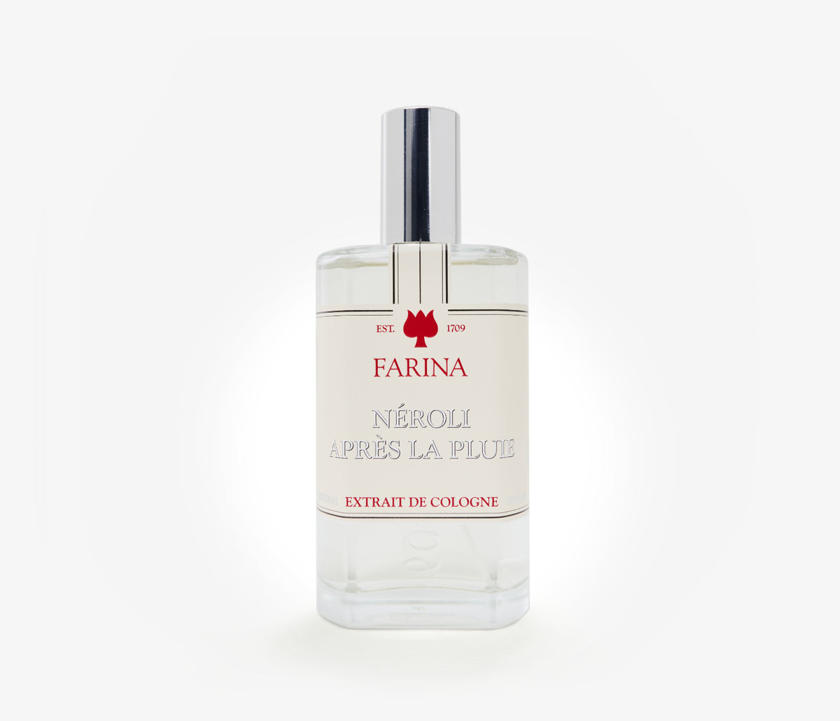 A bottle of the luxury perfume Néroli Àpres la Pluie by Farina 1709 set against a pale background.