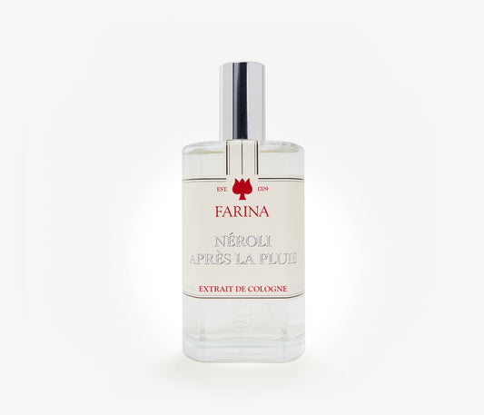 A bottle of the luxury perfume Néroli Àpres la Pluie by Farina 1709 set against a pale background.