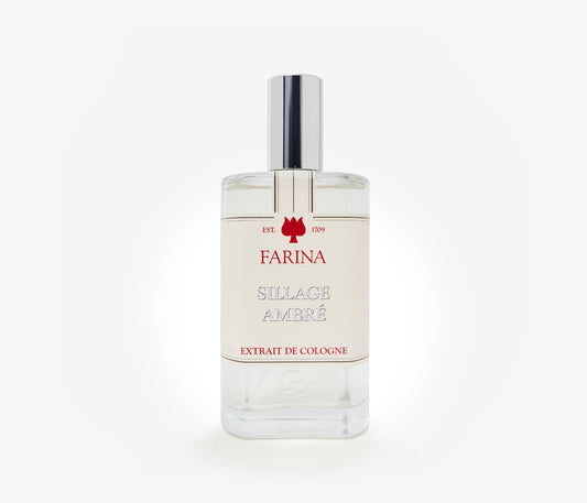 A bottle of the luxury perfume Sillage Ambre by Farina 1709 set against a pale background.