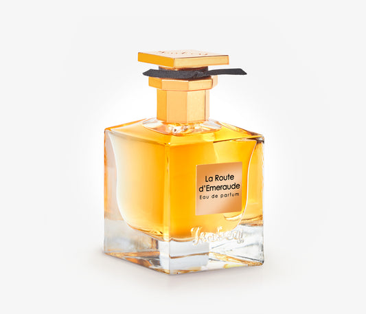 A bottle of Isabey La Route d'Emeraude exclusive luxury perfume on a pale grey backgound.