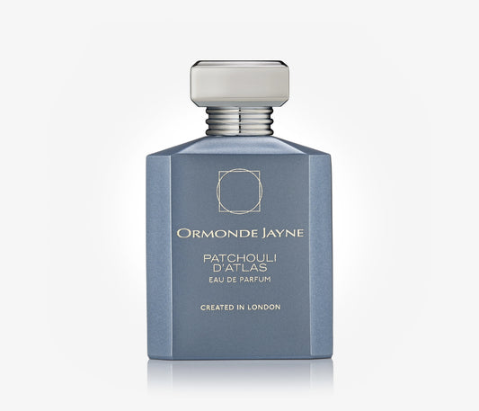 A bottle of niche perfume Patchouli D'Atlas by Ormonde Jayne on a pale grey background.